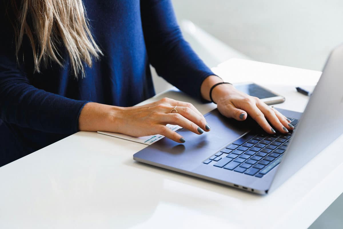 Woman Typing on Laptop