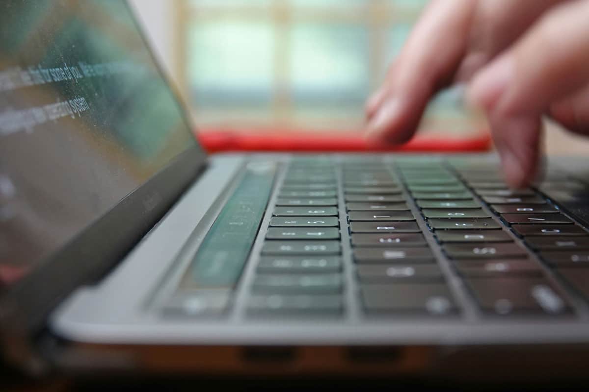 Typing Website Content on a Laptop